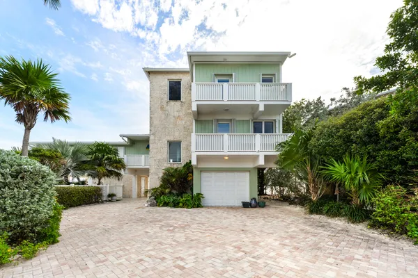 a view of a house with a small yard and plants