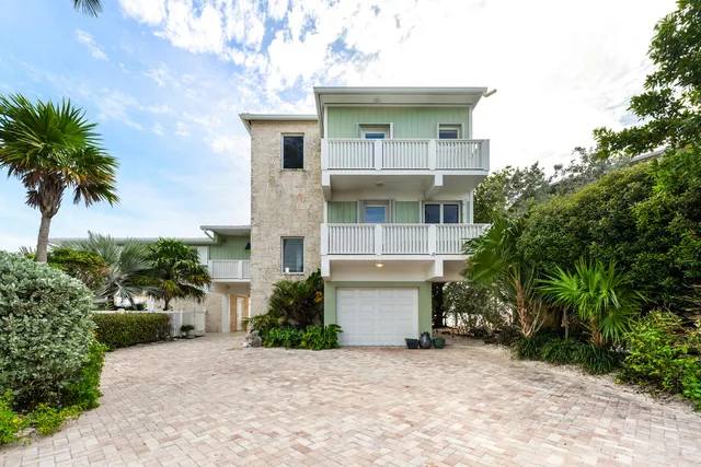 a view of a house with a small yard and plants
