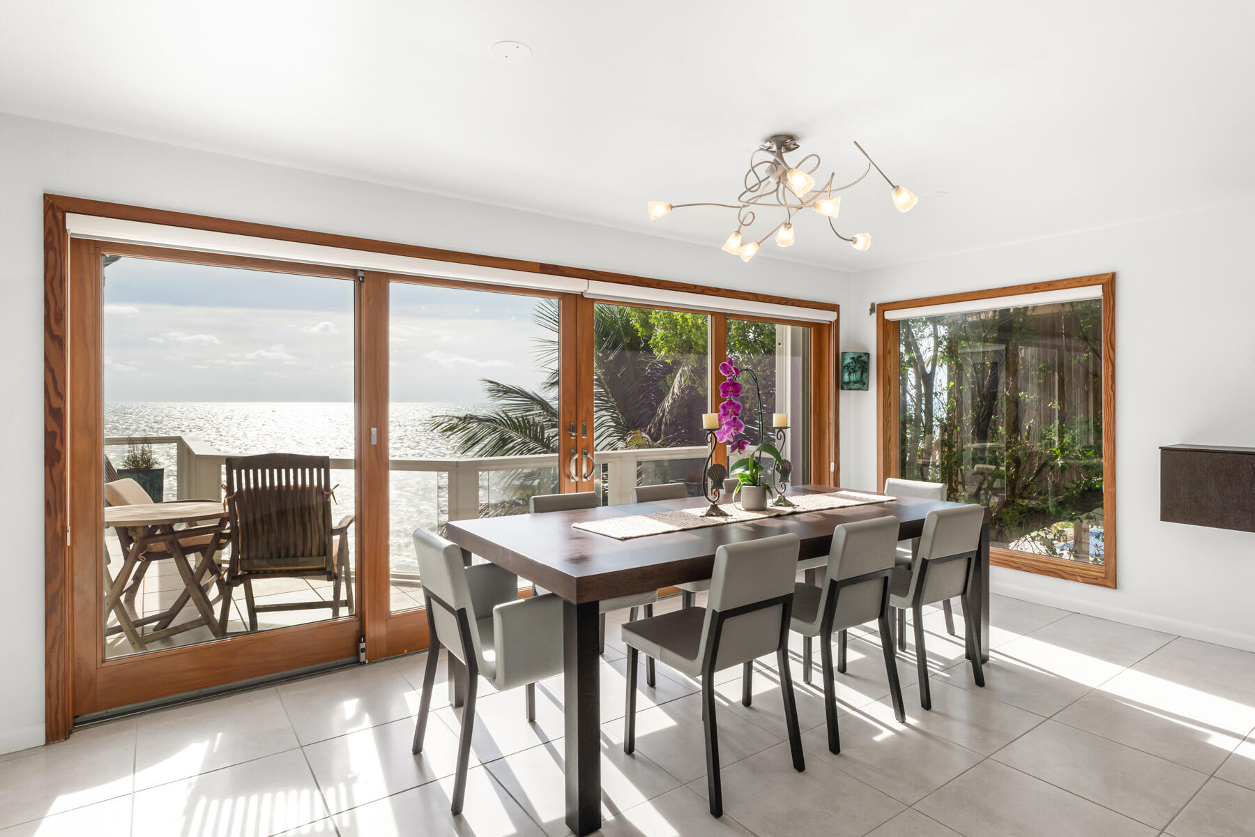 133 Sunset Drive Islamorada, FL 33036 - Photo 45 of 81 a view of a dining room with furniture large windows and wooden floor