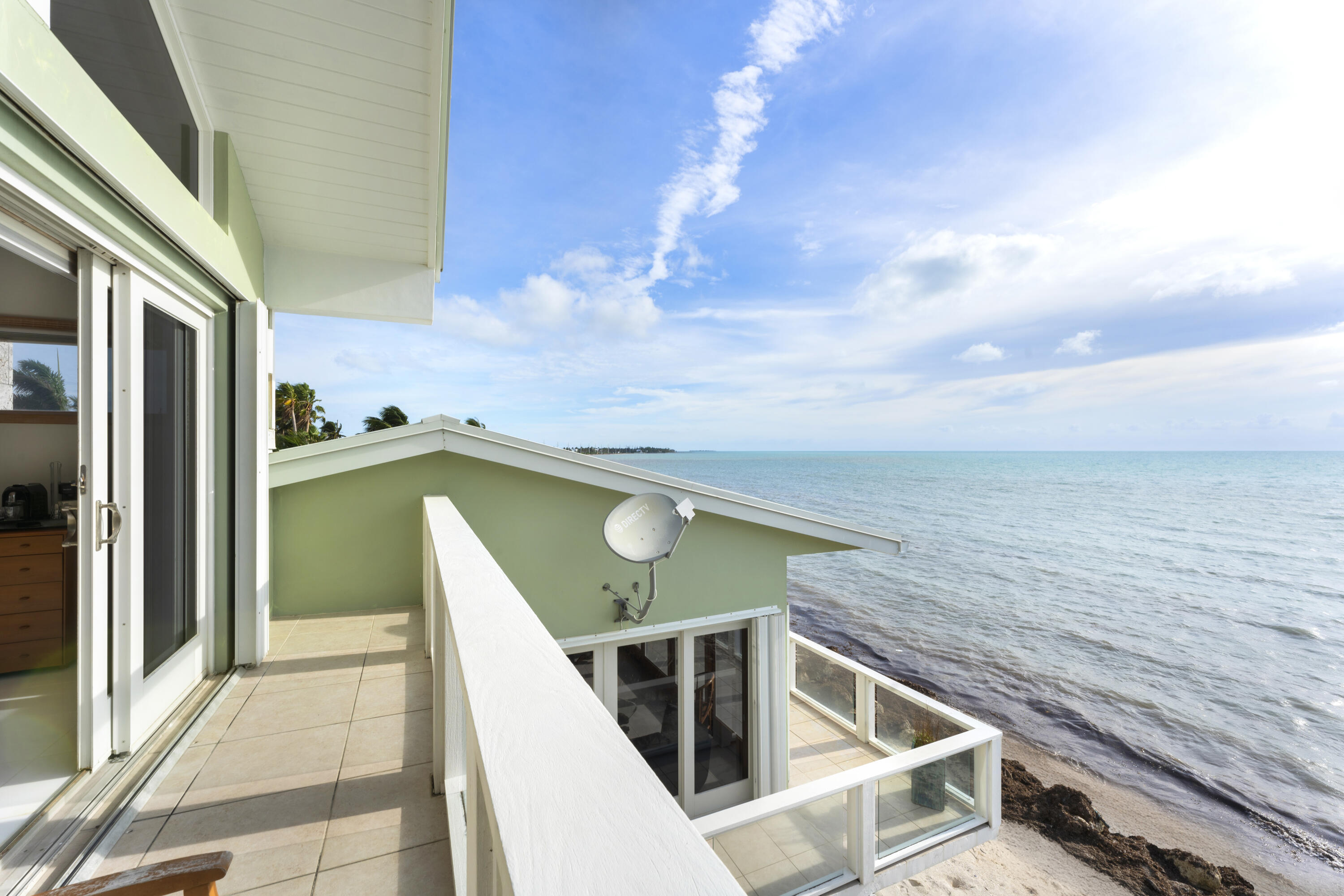 133 Sunset Drive Islamorada, FL 33036 - Photo 69 of 81 a view of a balcony with furniture and a kitchen