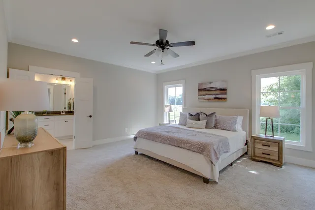 a spacious bedroom with a bed a couch and a window