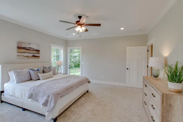 a bedroom with a large bed and a chandelier