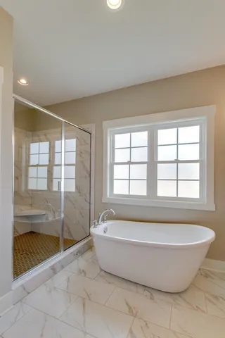 a spacious bathroom with a tub and shower