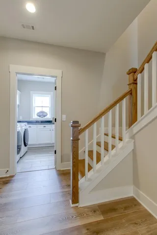 a view of a hallway view with wooden floor and staircase
