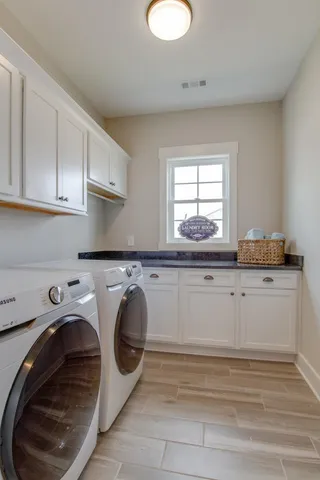 a utility room with sink dryer and washer
