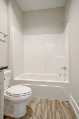 a bathroom with a toilet and a bathtub