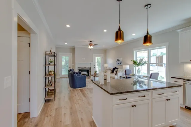 a kitchen with sink and living room view