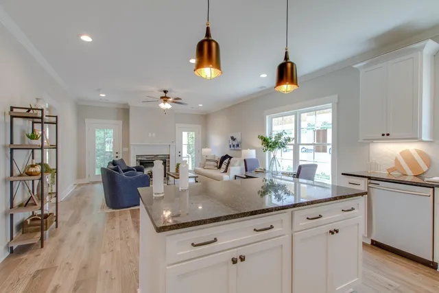 a kitchen with sink and chandelier