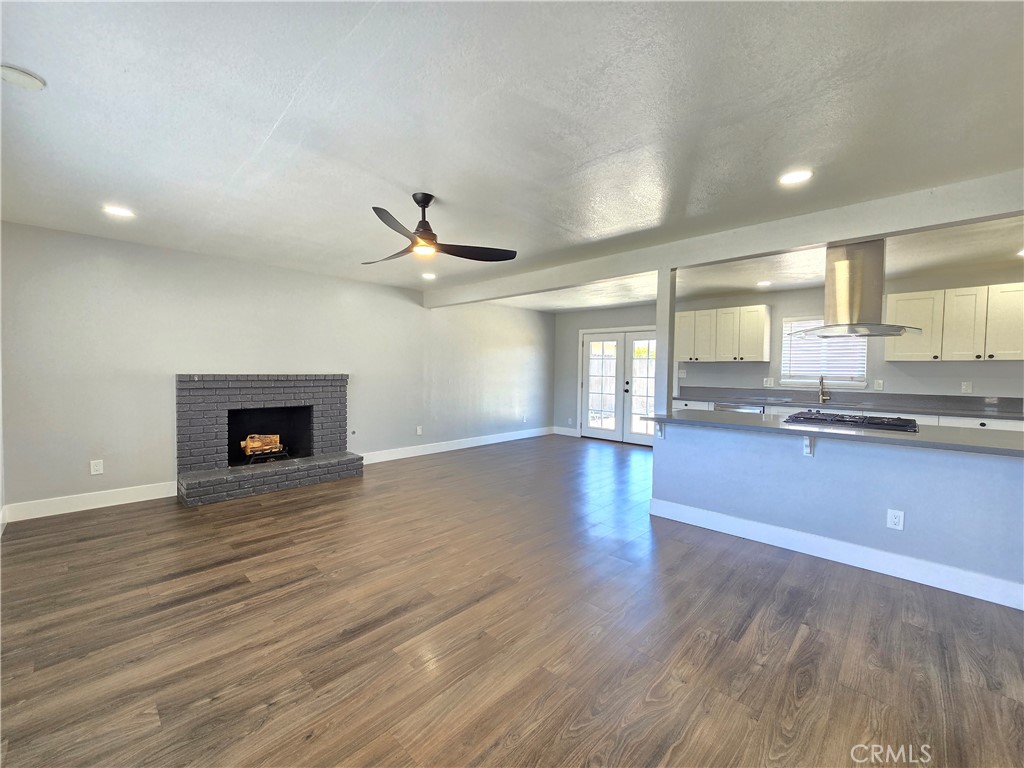 3404 Planz Road Bakersfield, CA 93309 - Photo 11 of 23 a large kitchen with granite countertop a stove and a wooden floor