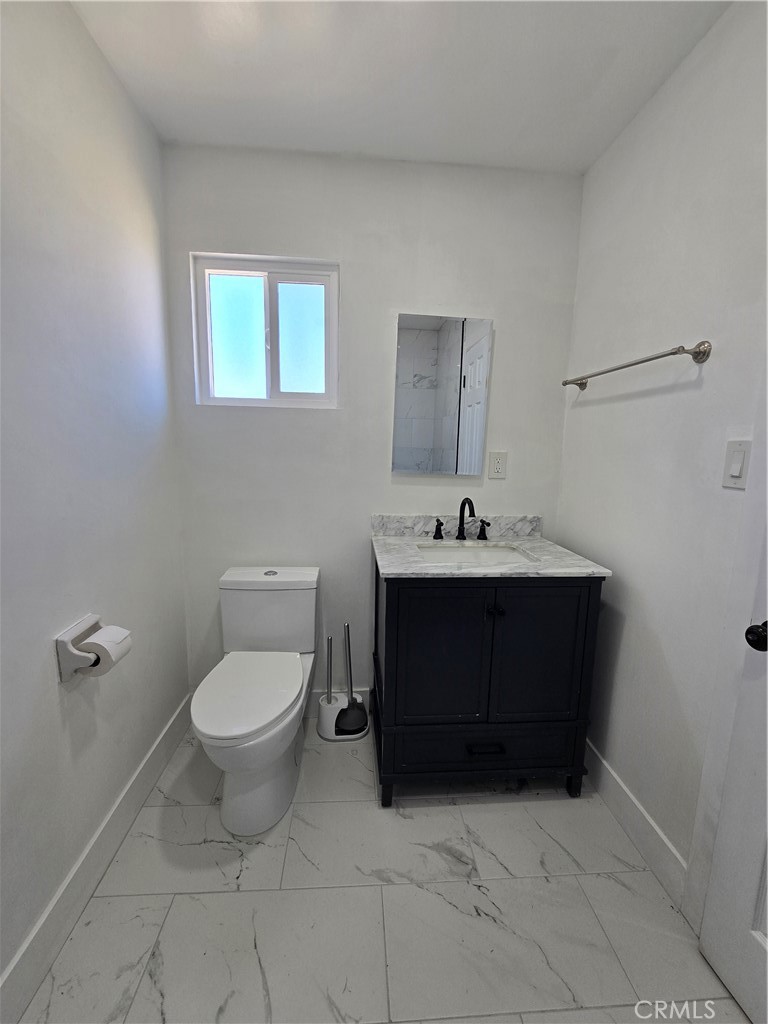 3404 Planz Road Bakersfield, CA 93309 - Photo 16 of 23 a bathroom with a sink toilet and vanity