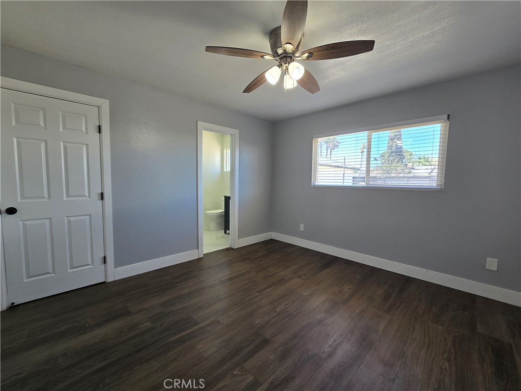 3404 Planz Road Bakersfield, CA 93309 - Photo 20 of 23 an empty room with wooden floor chandelier fan and windows