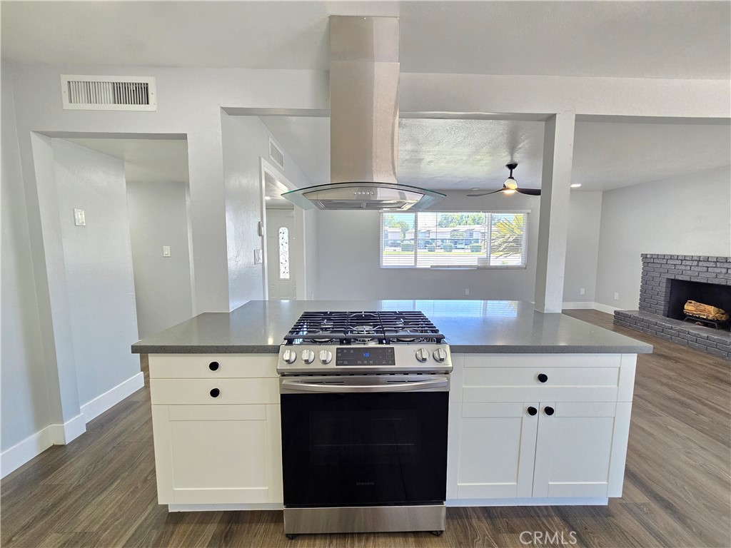 3404 Planz Road Bakersfield, CA 93309 - Photo 7 of 23 a kitchen with stainless steel appliances a stove and white cabinets