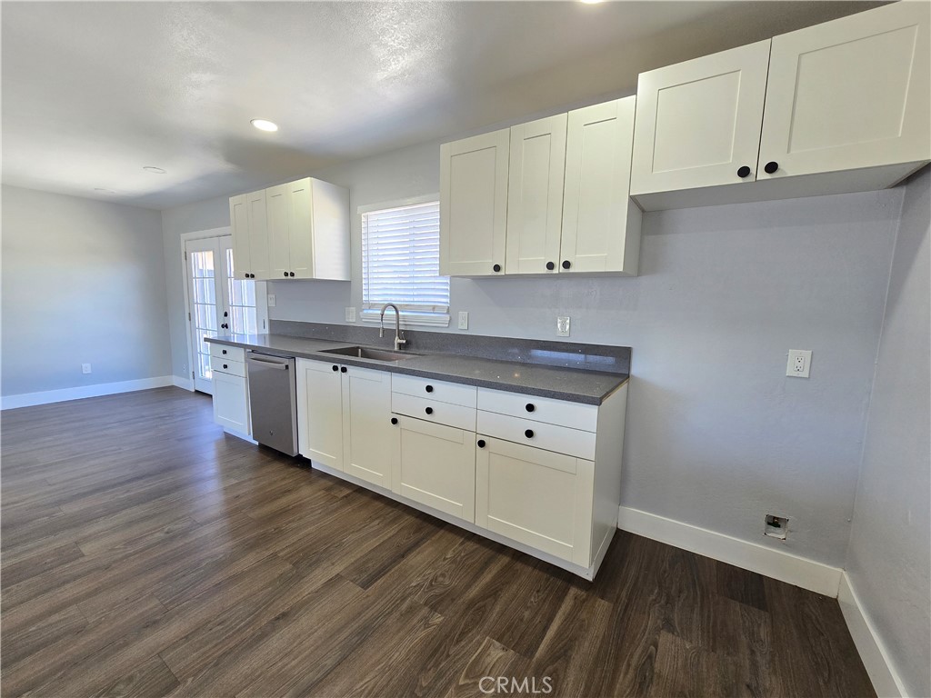 3404 Planz Road Bakersfield, CA 93309 - Photo 8 of 23 a kitchen with cabinets wooden floor and a sink