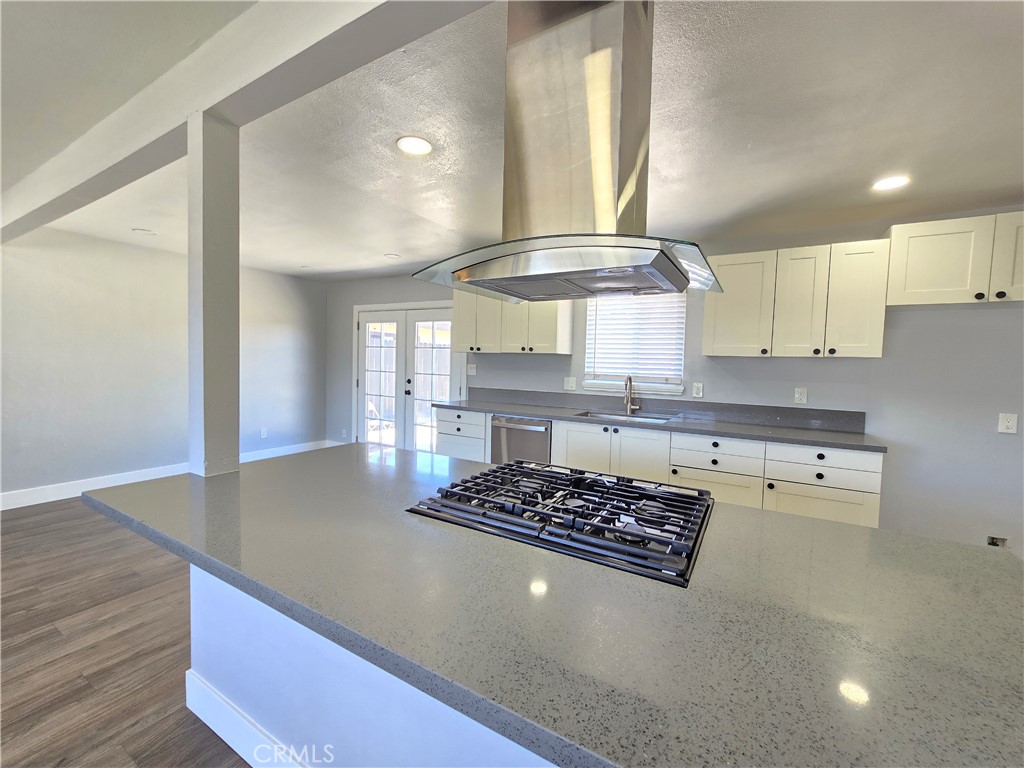 3404 Planz Road Bakersfield, CA 93309 - Photo 9 of 23 a kitchen with a stove a refrigerator and wooden cabinets