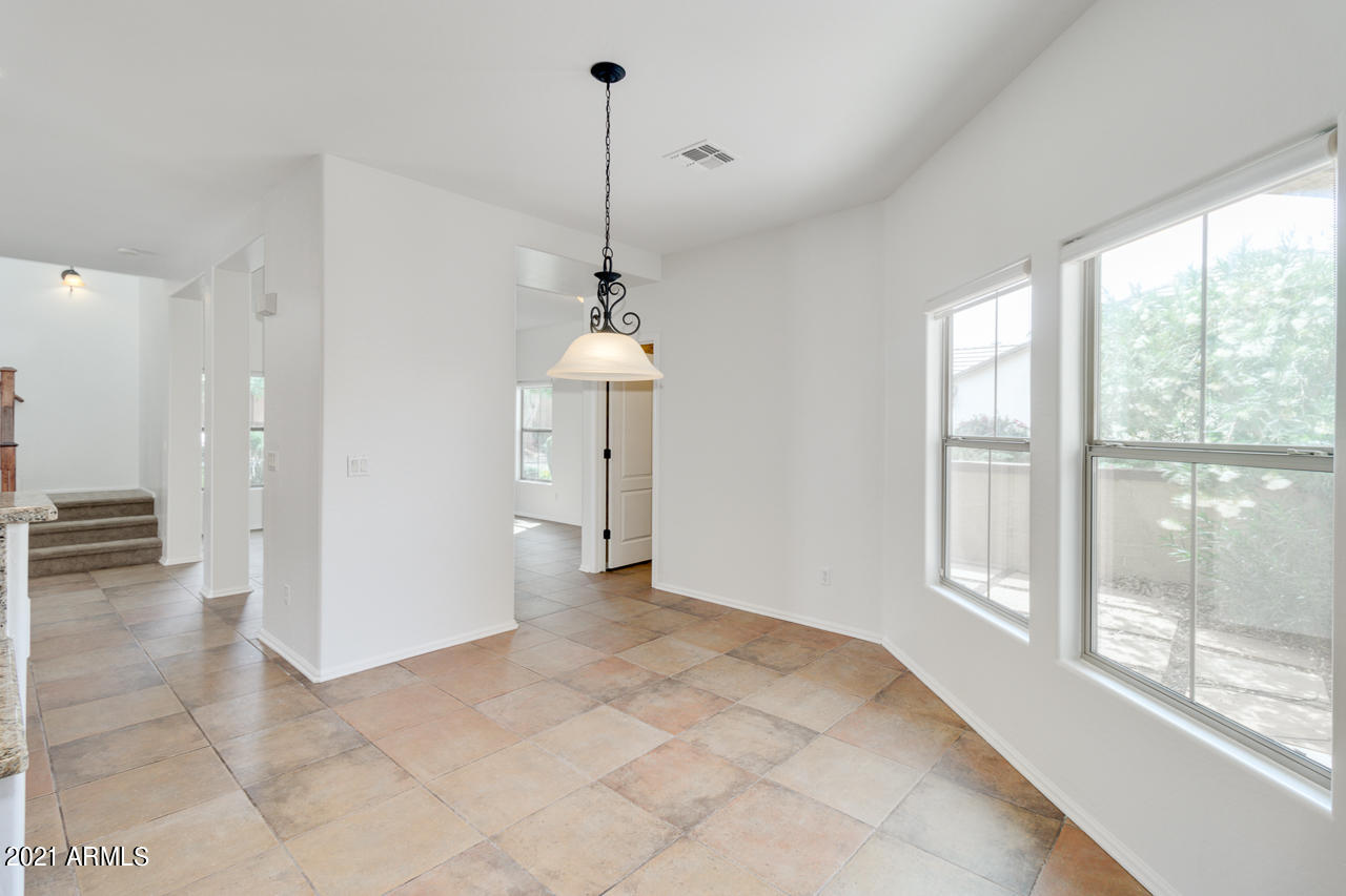 1074 South Hawk Lane Gilbert, AZ 85296 - Photo 14 of 35 a view of a room with a windows and ceiling fan