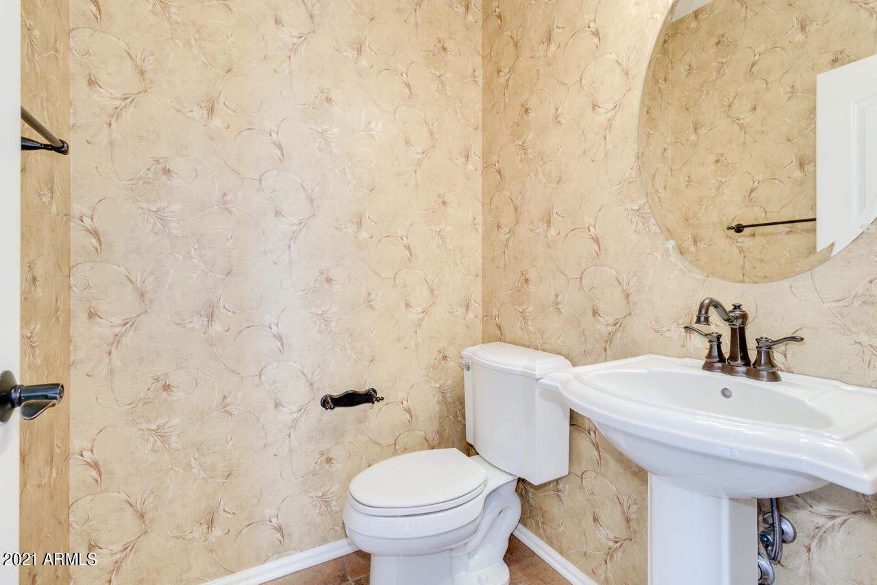1074 South Hawk Lane Gilbert, AZ 85296 - Photo 16 of 35 a bathroom with a sink a toilet and a mirror