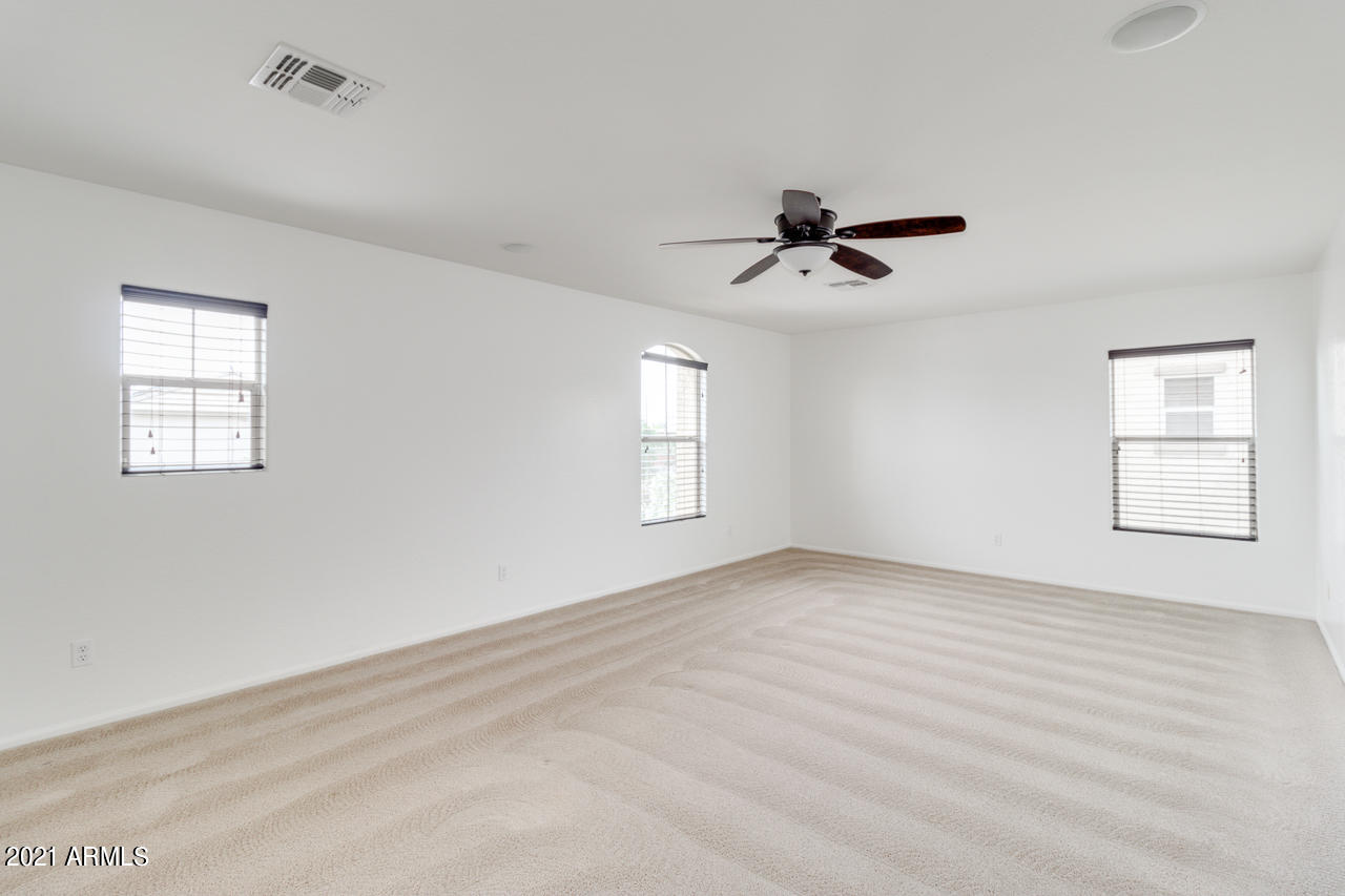 1074 South Hawk Lane Gilbert, AZ 85296 - Photo 17 of 35 a view of room with ceiling fan and window