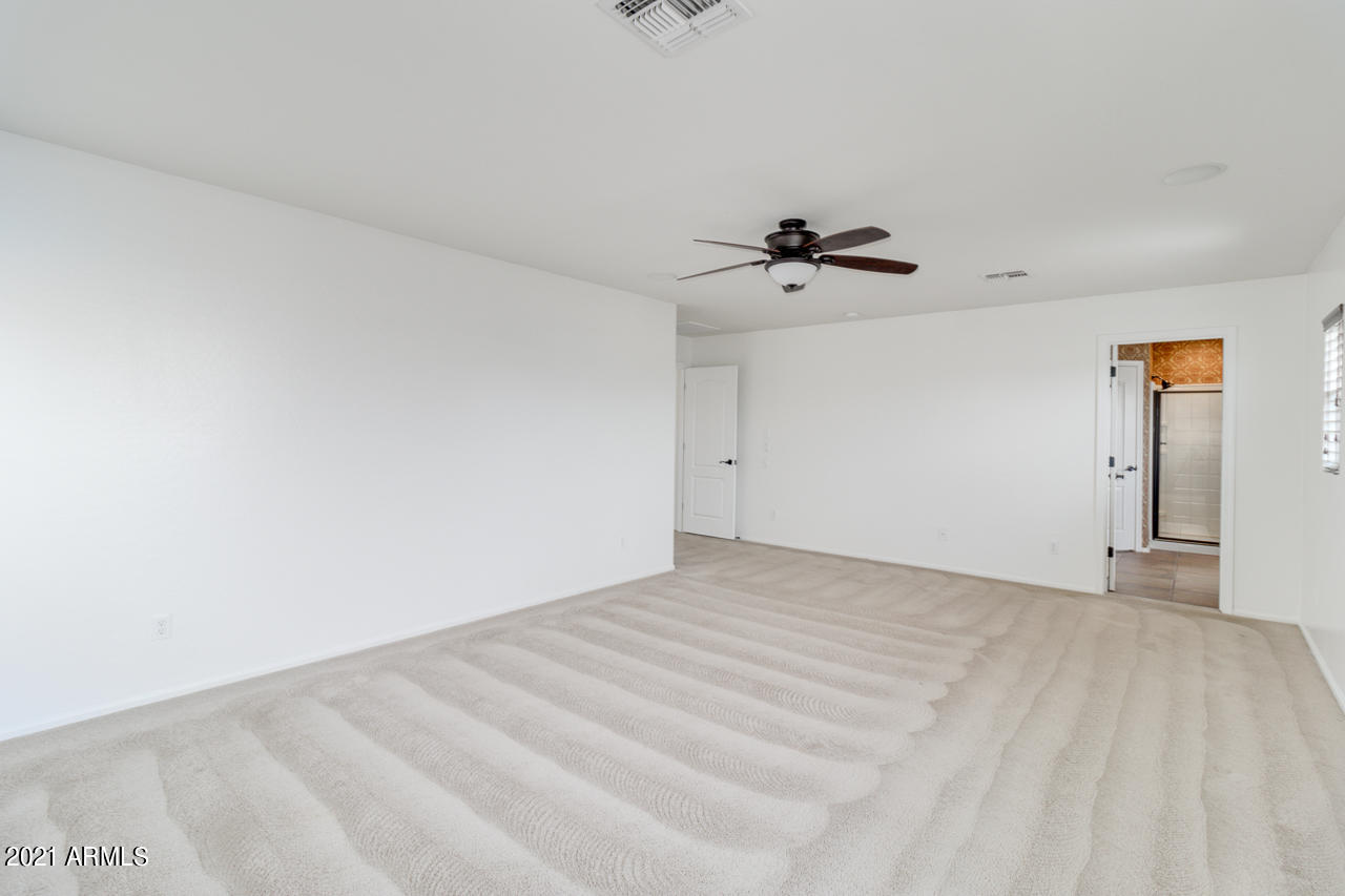 1074 South Hawk Lane Gilbert, AZ 85296 - Photo 19 of 35 a view of an empty room with a ceiling fan