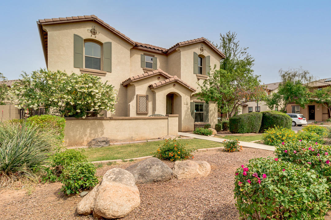 1074 South Hawk Lane Gilbert, AZ 85296 - Photo 2 of 35 a front view of a house with a yard and garage