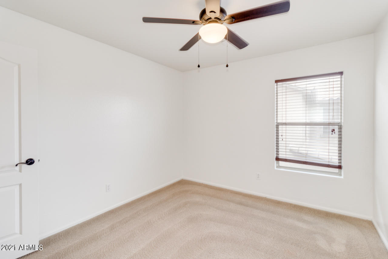 1074 South Hawk Lane Gilbert, AZ 85296 - Photo 24 of 35 an empty room with a window and a fan