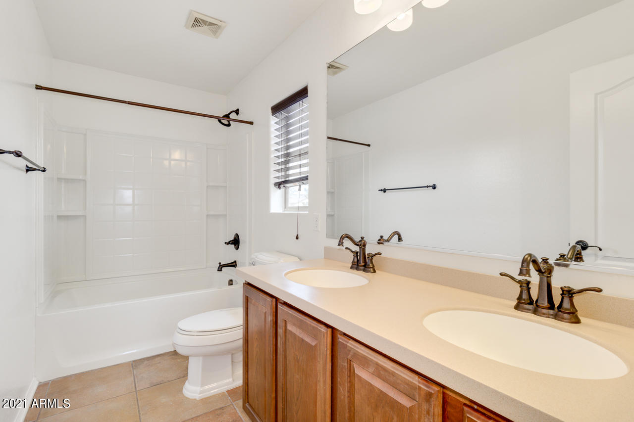 1074 South Hawk Lane Gilbert, AZ 85296 - Photo 25 of 35 a bathroom with a granite countertop sink toilet and shower