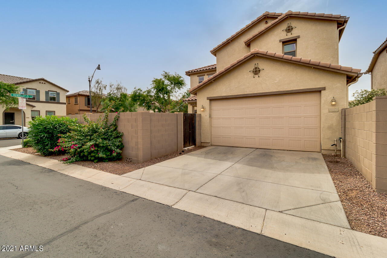 1074 South Hawk Lane Gilbert, AZ 85296 - Photo 35 of 35 a front view of a house with a yard and garage
