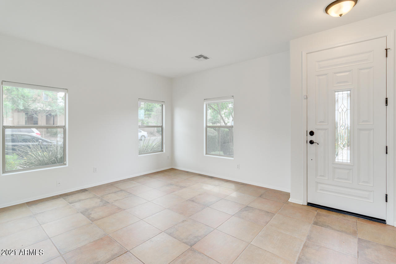 1074 South Hawk Lane Gilbert, AZ 85296 - Photo 4 of 35 a view of an empty room with a window