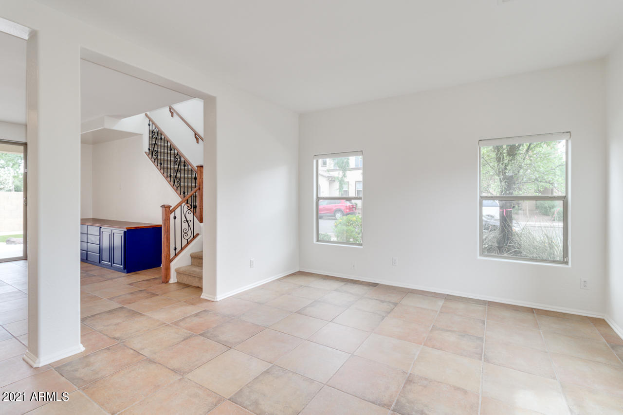 1074 South Hawk Lane Gilbert, AZ 85296 - Photo 5 of 35 an empty room with windows and stairs