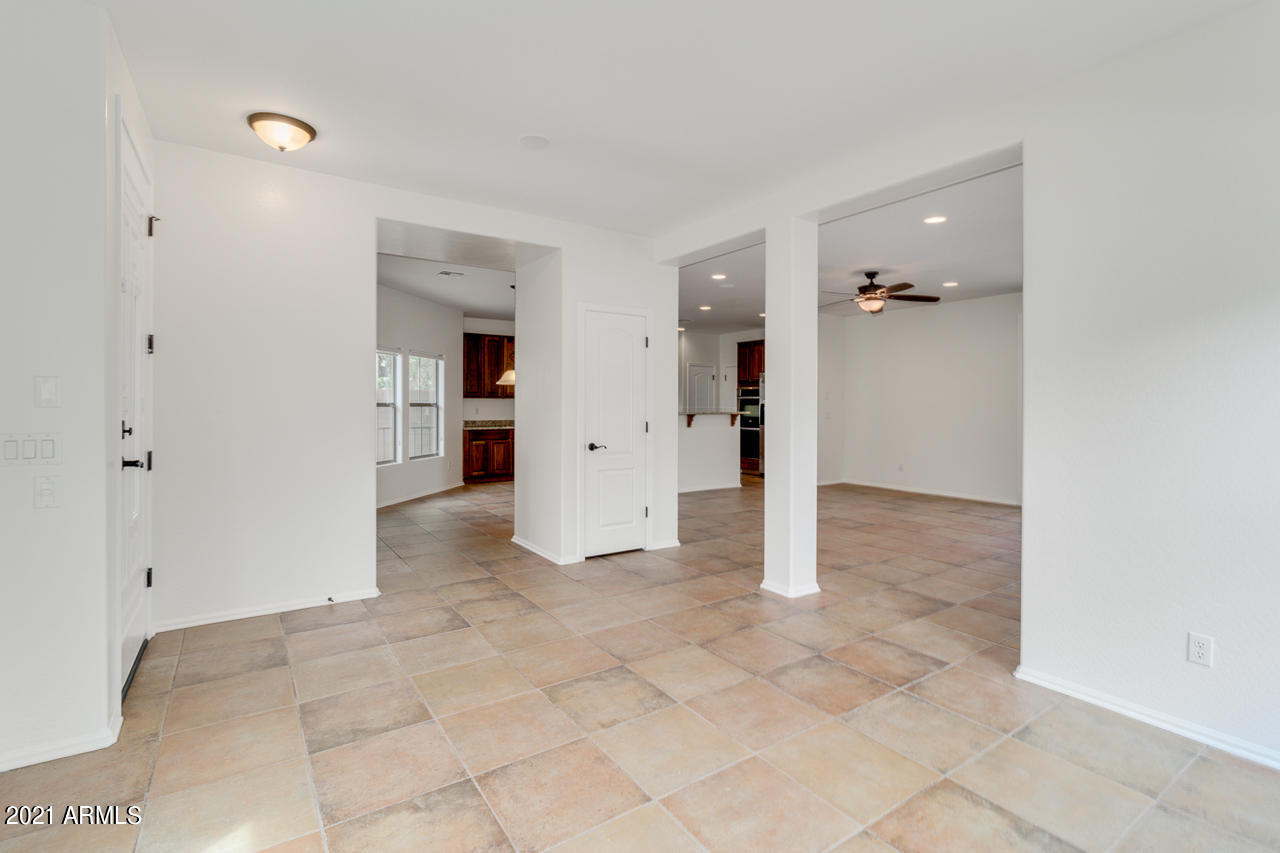 1074 South Hawk Lane Gilbert, AZ 85296 - Photo 6 of 35 a view of a livingroom with a kitchen space and windows
