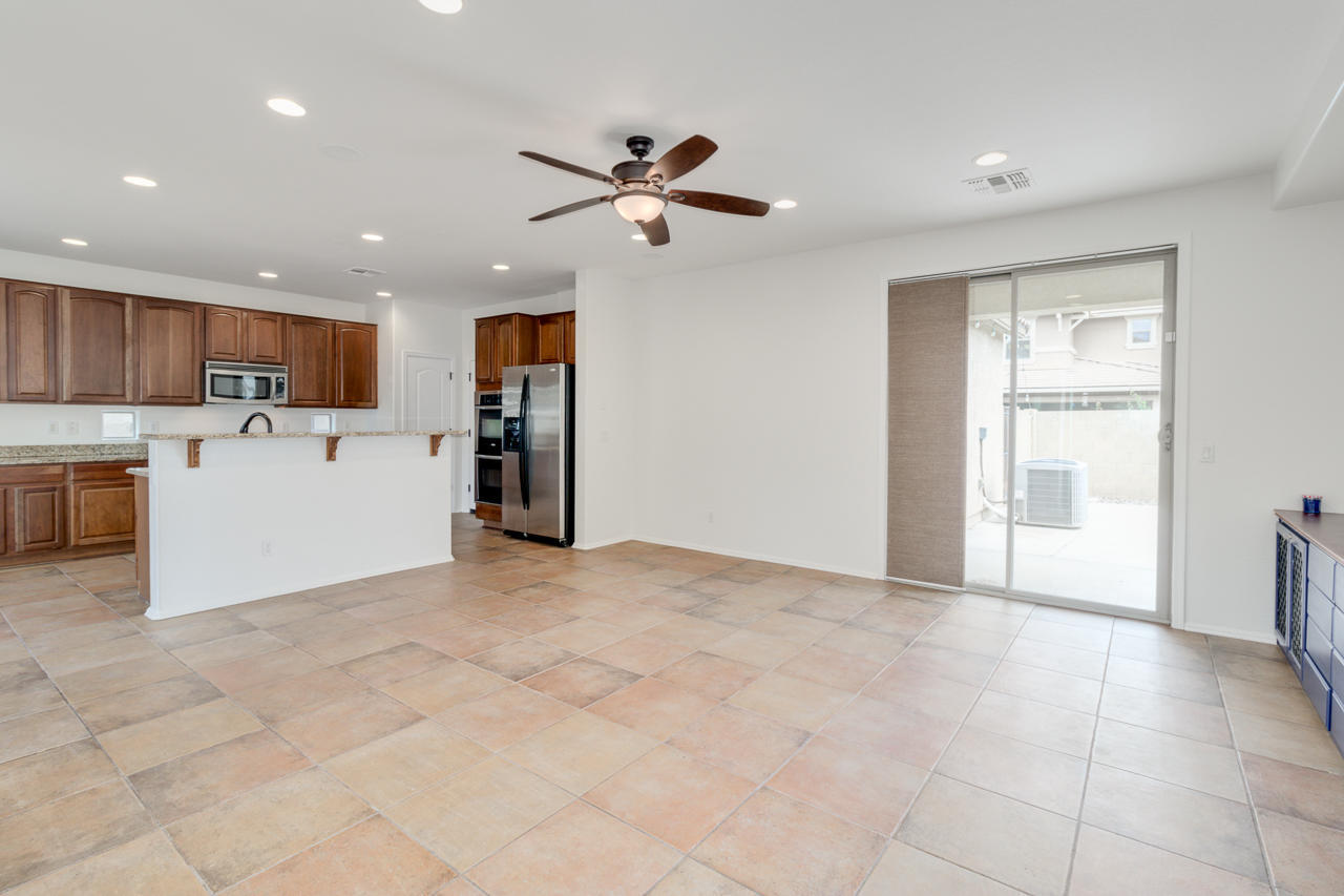 1074 South Hawk Lane Gilbert, AZ 85296 - Photo 8 of 35 a view of a kitchen with a sink and a refrigerator