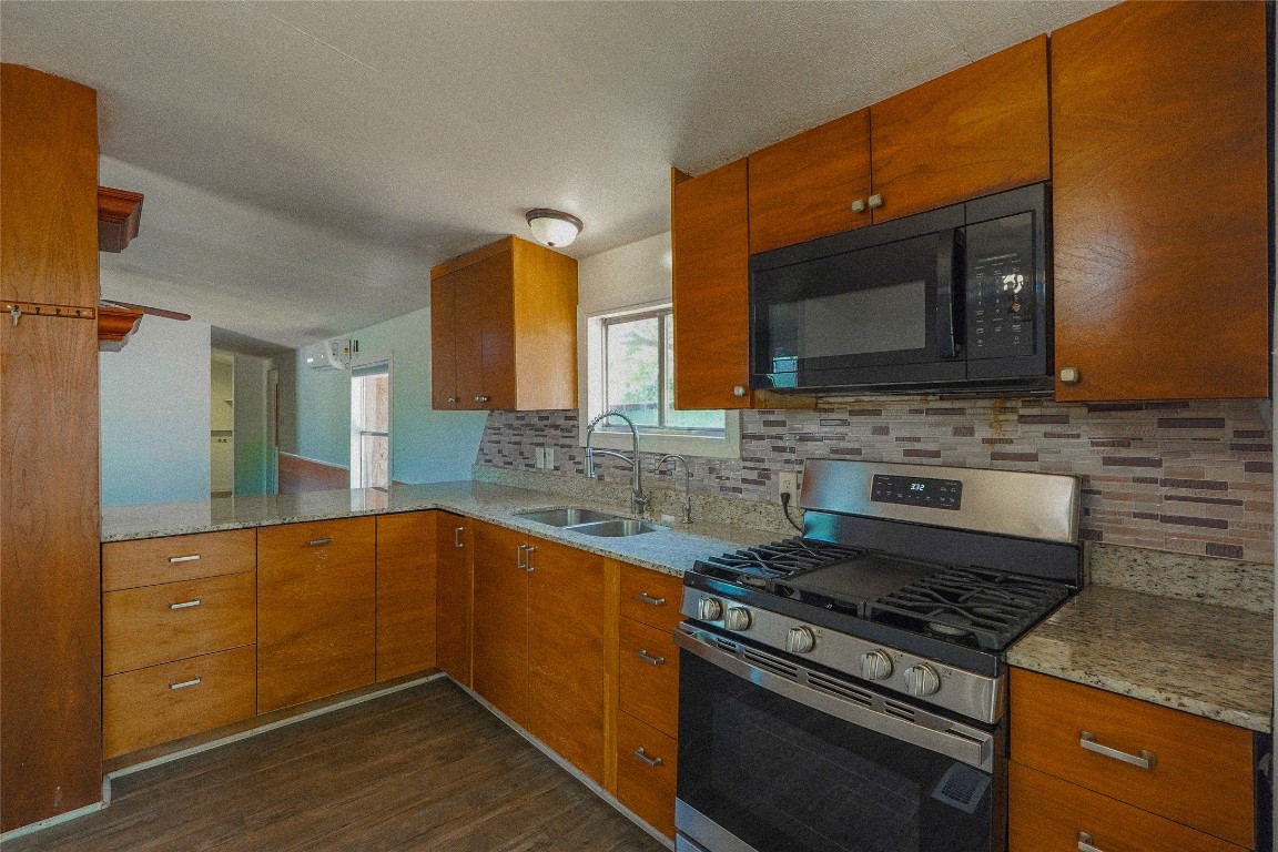 155 5th Street Maxwell, TX 78656 - Photo 3 of 34 a kitchen with stainless steel appliances a stove a sink and a microwave