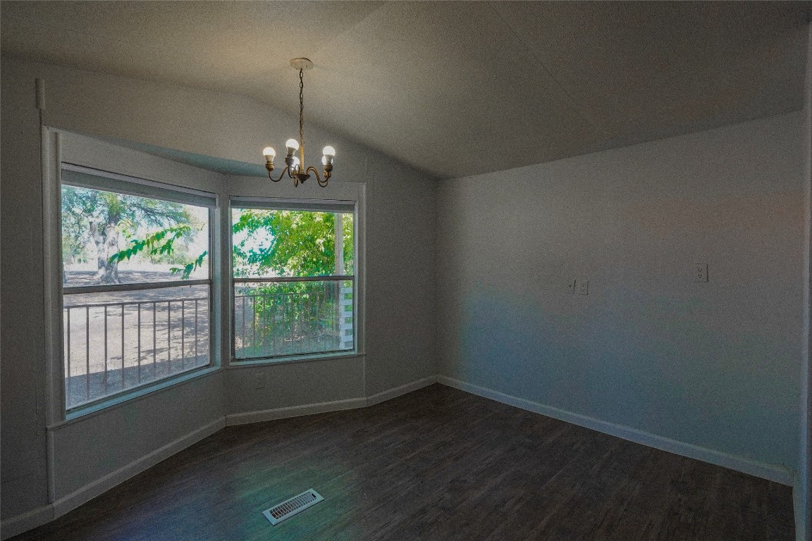 155 5th Street Maxwell, TX 78656 - Photo 7 of 34 a view of an empty room with wooden floor and a window