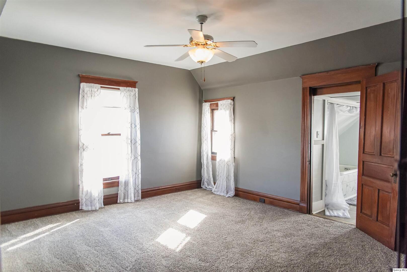 512 Madison Street Quincy, IL 62301 - Photo 4 of 15 an empty room with windows and fan