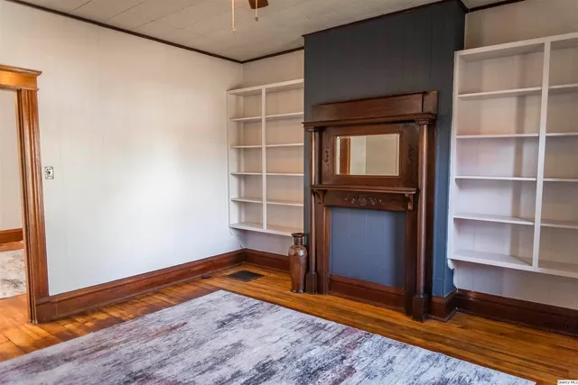 a view of a room with wooden floor and a window