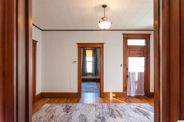 a view of hallway with wooden floor