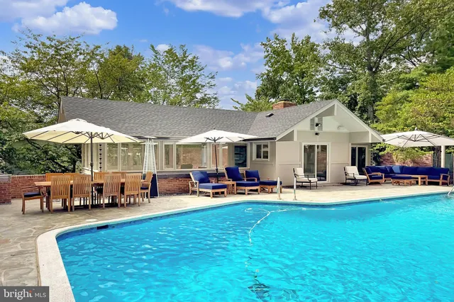 a dining room with furniture a chandelier and wooden floor