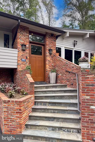 a kitchen with a sink and a stove next to a window