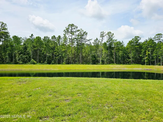 a view of swimming pool with a yard
