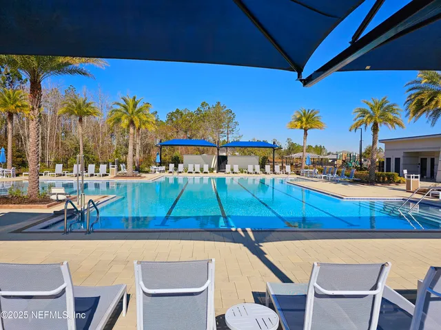 a view of swimming pool with outdoor seating