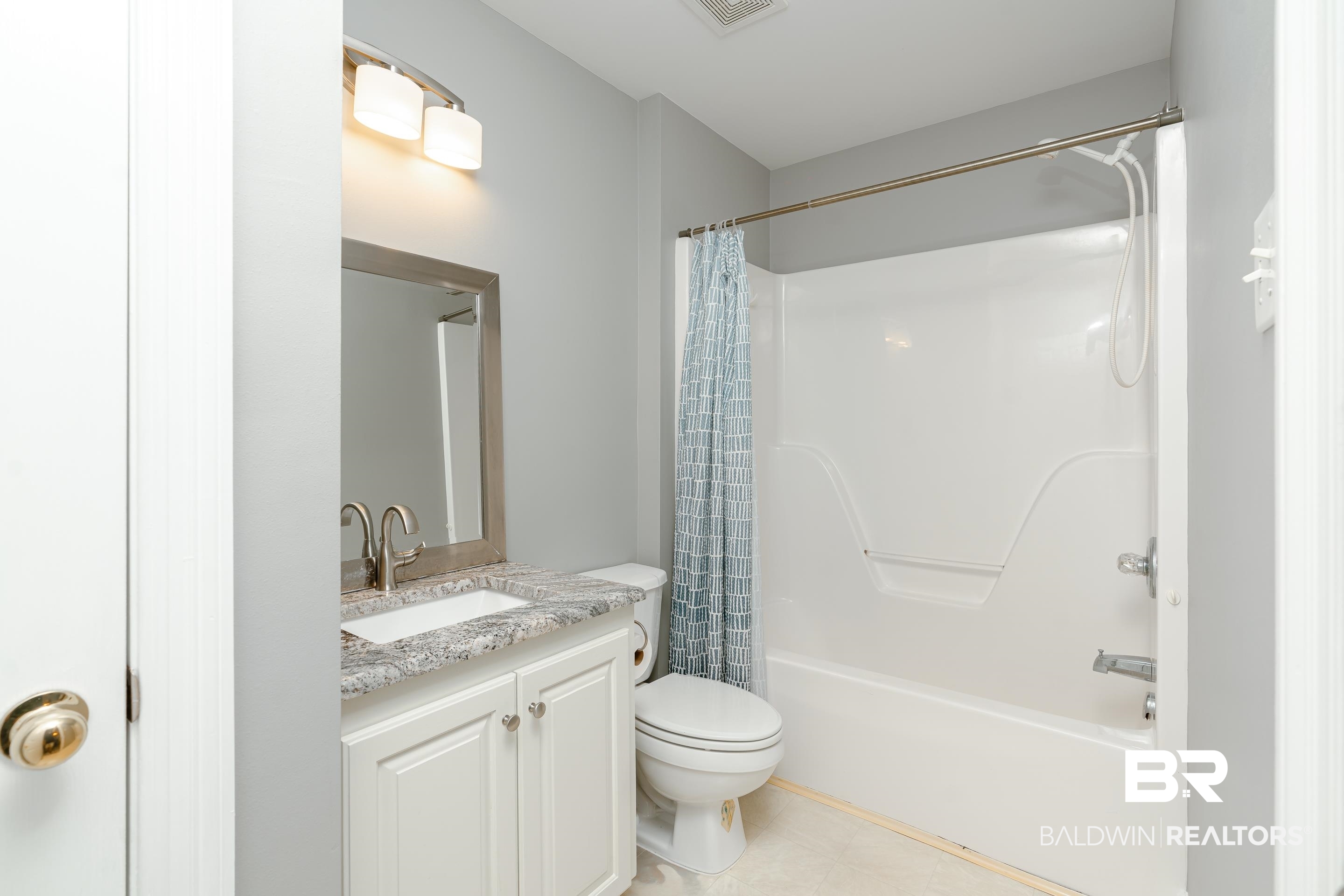 9477 Deerfield Drive Irvington, AL 36544 - Photo 31 of 58 Full bathroom with shower / bath combination with curtain, toilet, vanity, and tile patterned floors