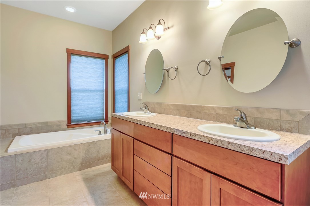 816 Red Maple Loop Everson, WA 98247 - Photo 11 of 22 a bathroom with a double vanity sink and a mirror
