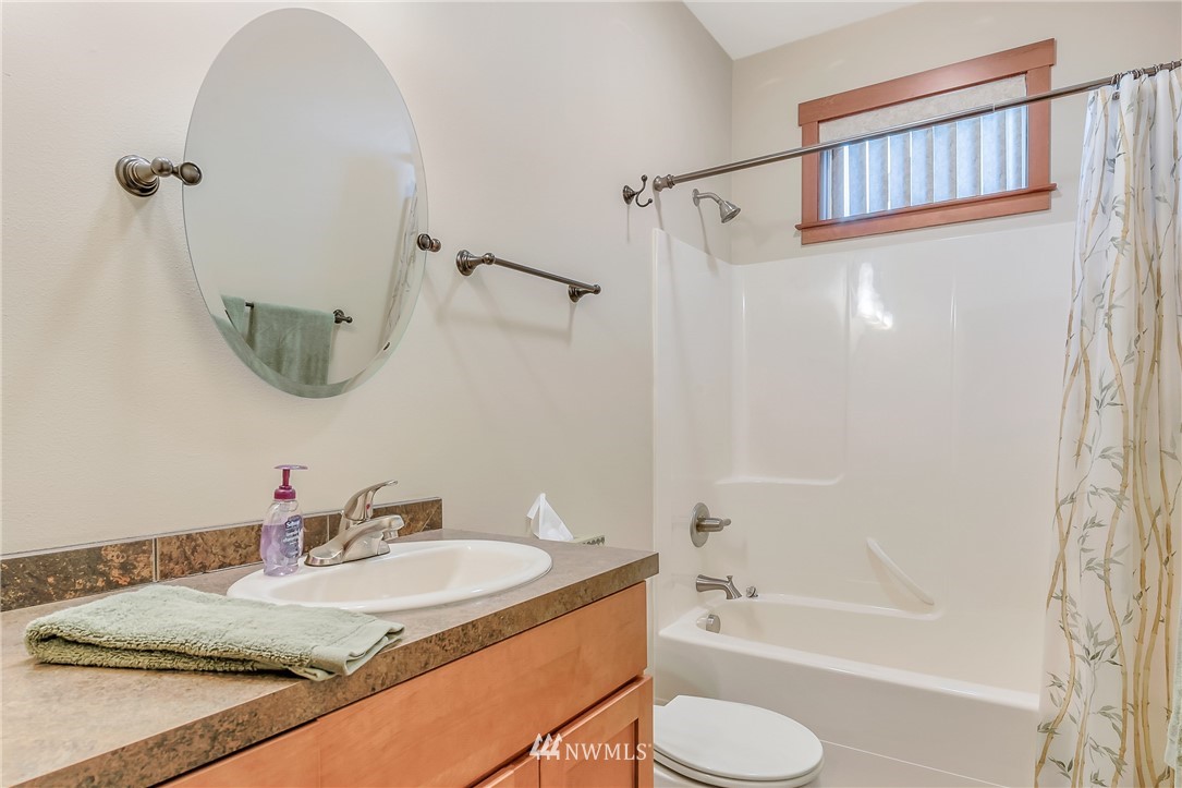 816 Red Maple Loop Everson, WA 98247 - Photo 14 of 22 a bathroom with a granite countertop sink toilet and shower