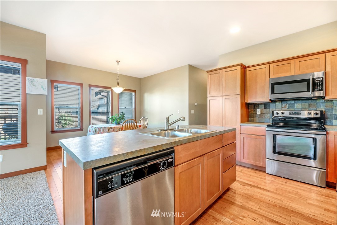 816 Red Maple Loop Everson, WA 98247 - Photo 6 of 22 a kitchen with stainless steel appliances granite countertop a stove and a sink