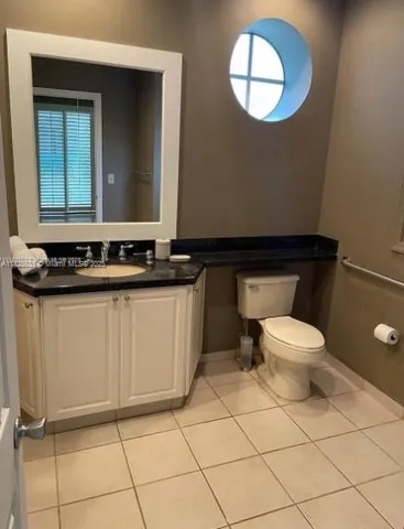 a bathroom with a toilet a sink and mirror