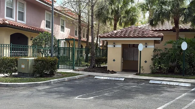 a view of a white house with a large windows and a yard