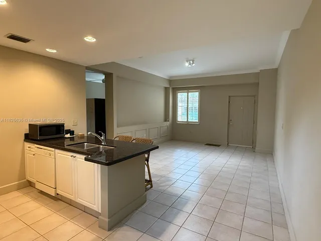 a kitchen with a sink and a stove top oven