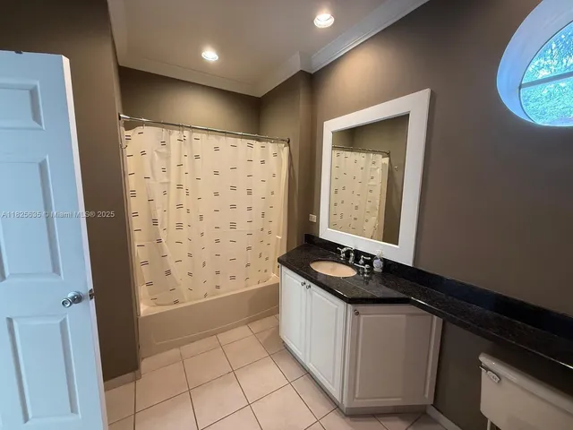 a bathroom with a granite countertop sink a shower and a mirror