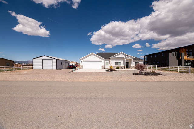 745 East 885 North Beaver, UT 84713 - Photo 2 of 50 View of front of home with a garage, an outbuilding, and driveway