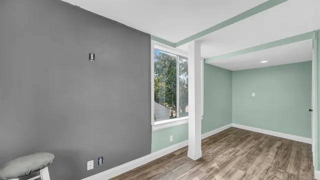 wooden floor in an empty room with a window