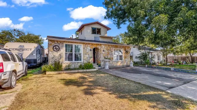 a view of a house with wooden fence
